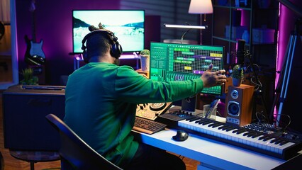Poster - Skilled audio technician editing recorded tracks from an usb stick, using raw files to apply mix and master techniques. Artist producing music, adjusting volume levels on digital software. Camera B.