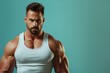 © kitipol - Close-up of a fit, muscular man confidently presenting against a solid color background, emphasizing both his intelligence and powerful physique in a strong, dynamic pose
