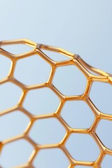 Poster - Close-up of a shiny golden honeycomb structure against a soft blue background, showcasing intricate designs.