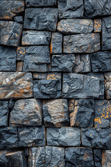 Poster - This black stone wall features a unique texture created by rectangular blocks of varying sizes. The arrangement showcases natural variations in color and surface, adding depth and interest.