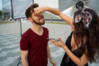 © phoenix021 - Make up on the film set, or photo shoot outdoors, woman makeup artist putting on makeup on male actor. Behind the scenes