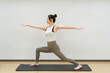 © megane - young asian beauty woman doing yoga at studio Warrior Pose