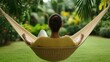 © Intelligent Horizons - Woman relaxing in a hammock completely at peace surrounded by the lush greenery and shade of a tranquil garden paradise  A serene and idyllic scene of rest and solace
