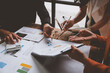 © Phimwilai - Teamwork process Team of business men and women use calculators to calculate numbers, business statistics, profits, cost analysis, graph documents, growth rates. Data chart on the desk.