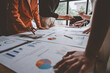 © Phimwilai - Team, group of business people using calculators to calculate reports Summary of financial information Accounting documents, marketing documents, business growth at the office, business meeting ideas.