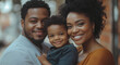 © Anuson - Happy family portrait of smiling parents and their son with beautiful smiles looking at the camera