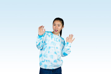 Wall Mural - Yougn Asian girl with blue dress points and gives various expression and gestures isolated happy sad