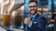 © eartist85 - Confident smiling businessman showing thumb up gesture.