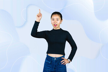 Wall Mural - Young Asian Girl gives gestures of pointing presenting, expression of happy, sad, wow