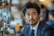 © Borasca - Confident businessman in modern office setting