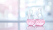 © Nattapol - Close up of laboratory flasks with pink liquid on table, showcasing vibrant colors and scientific exploration. scene evokes curiosity and innovation
