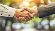 © Dodoodle - Close-up handshake symbolizing agreement and trust with warm lighting and professional setting