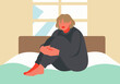© Westend61 - Woman hugging knees and sitting on bed at home