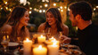 © stefanholm - Three friends share smiles and laughter over a candle-lit dinner, with warm, glowing light from bokeh string lights enhancing the cozy outdoor ambiance in a relaxed setting.