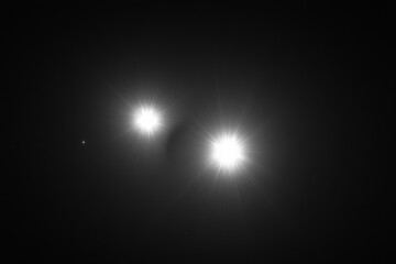 Poster - This image captures two bright celestial objects emitting brilliant light in a vast, dark space, symbolizing cosmic duality and stellar beauty, enhanced by lens flare.