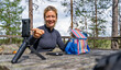 © ADDICTIVE STOCK - Smiling woman enjoys lunch during trek in Lapland, Sweden