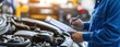 © diwek - Car Mechanic Inspecting Engine