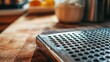 © Павел Гризунов - A close-up shot of the grater's edge, highlighting the sharpness and texture, with the cutting board softly blurred behind.