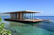© ChaoticMind - A sleek, contemporary floating house sits elegantly on clear turquoise waters, offering a luxurious retreat with panoramic ocean views and ample natural light.