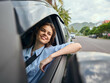 © SHOTPRIME STUDIO - Smiling young woman in a car's passenger seat rests her hand on the steering wheel, gazing out the window during a road trip, capturing the essence of travel, freedom, and exploration