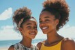© vefimov - Smiling mother and daughter enjoying a sunny beach day.