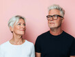 © Amy - Happy Senior Couple with Gray Hair Posing Together in Front of Pink Background