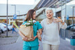 © Dragana Gordic - Young Caregiver Assisting Elderly Woman with Shopping Outdoors