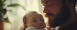 © Itsaree  - Touching closeup of a father holding his young baby, capturing the beauty of new parenthood, soft focus, heartwarming atmosphere