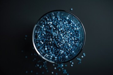 Poster - A decorative crystal bowl filled with blue crystals sitting on a table
