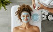 © Sebelas Studio - A woman enjoys a facial treatment with a blue mask at a spa.