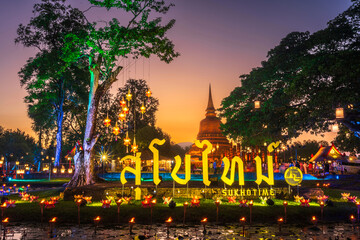 Wall Mural - Beautiful scene of The light color Sukhothai Co Lamplighter Loy Kratong Festival at The Sukhothai Historical Park covers the ruins of Sukhothai, in what is now Northern Thailand.