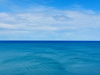 Wall Mural - blue calm sea and cloudy sky.