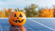 © Robert Kneschke - Halloween pumpkin on solar panel with autumn background