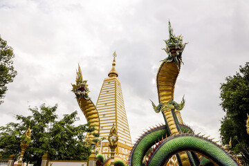 Wall Mural - Wat Phra That Nong Bua, Ubon Ratchathani, inside there is the Phra That Sri Maha Bodhi Chedi, a replica of the Chedi in Bodh Gaya, India, stucco sculptures, candles, and two large Naga statues.