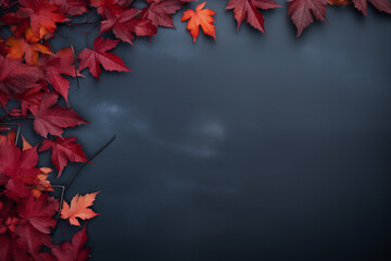 Wall Mural - Bright red autumn maple leaves frame on dark blue stone background