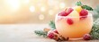 © praewpailyn - Refreshing drink with raspberries and tropical fruits in a glass, garnished with herbs and cinnamon, set against a soft, festive background.