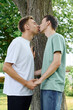© Bliss - Two men share a tender kiss while holding hands, surrounded by natures beauty.