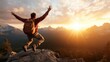 © Dulemegapixel - Standing on a peak, a person is captured in an energetic pose against a backdrop of emerging sunlight over mountain ranges, celebrating the thrill of the climb.