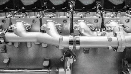 Poster - A large engine with many parts. The engine is made of metal and has many pipes and valves. The concept of industrialization and complexity of machines