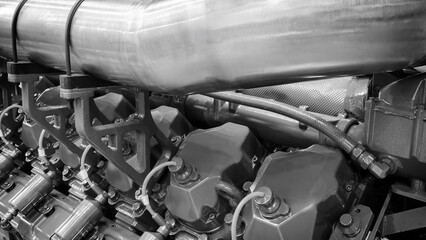Poster - A large engine with many parts. The engine is made of metal and has many pipes and valves. The concept of industrialization and complexity of machines
