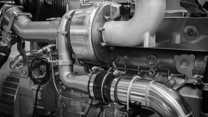 Poster - A large engine with many parts. The engine is made of metal and has many pipes and valves. The concept of industrialization and complexity of machines