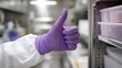© Keattipoom - Hand in Purple Rubber Gloves Giving a Thumbs Up