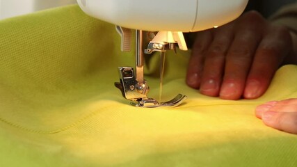 Wall Mural - The process of sewing fabric on a sewing machine, The sewing machine needle in motion