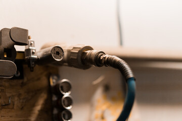 Detailed Close-Up of a Pneumatic Hose Connector Mounted in a Workshop