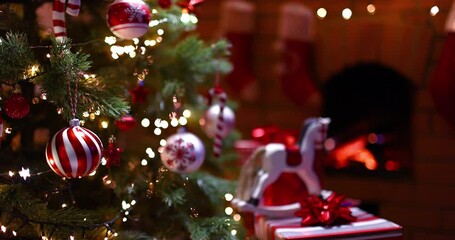 Wall Mural - christmas tree decorated with beautiful toys and gifts near the fireplace with fire