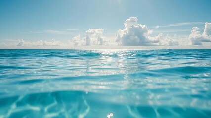 a tranquil ocean background with clear blue water, gentle waves, and a bright sun shining in the sky
