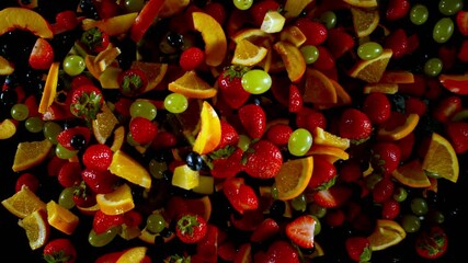Fototapete - Super Slow Motion of Flying Fruit Up in the Air, Top View. Filmed on High Speed Cinema Camera, 1000 fps. Isolated on Black Background.