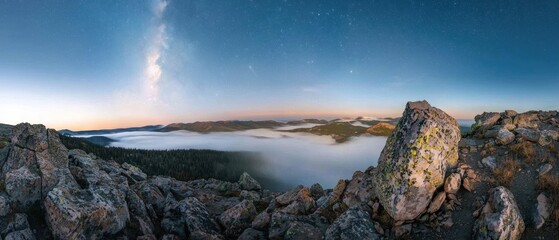 Wall Mural - A beautiful mountain view with a large rock in the foreground