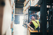 © Davor - Warehouse worker operating forklift in storage aisle