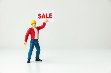 Wall Mural - toy man holding a sign with the text (Sale)